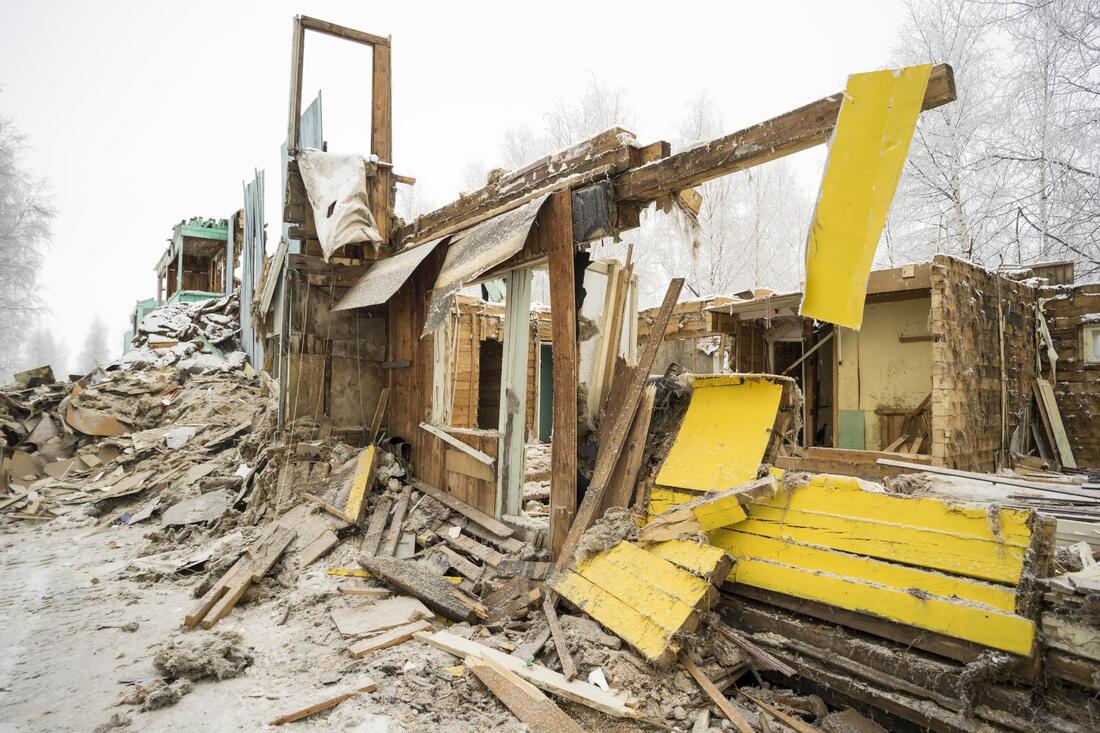 damage house being demolished